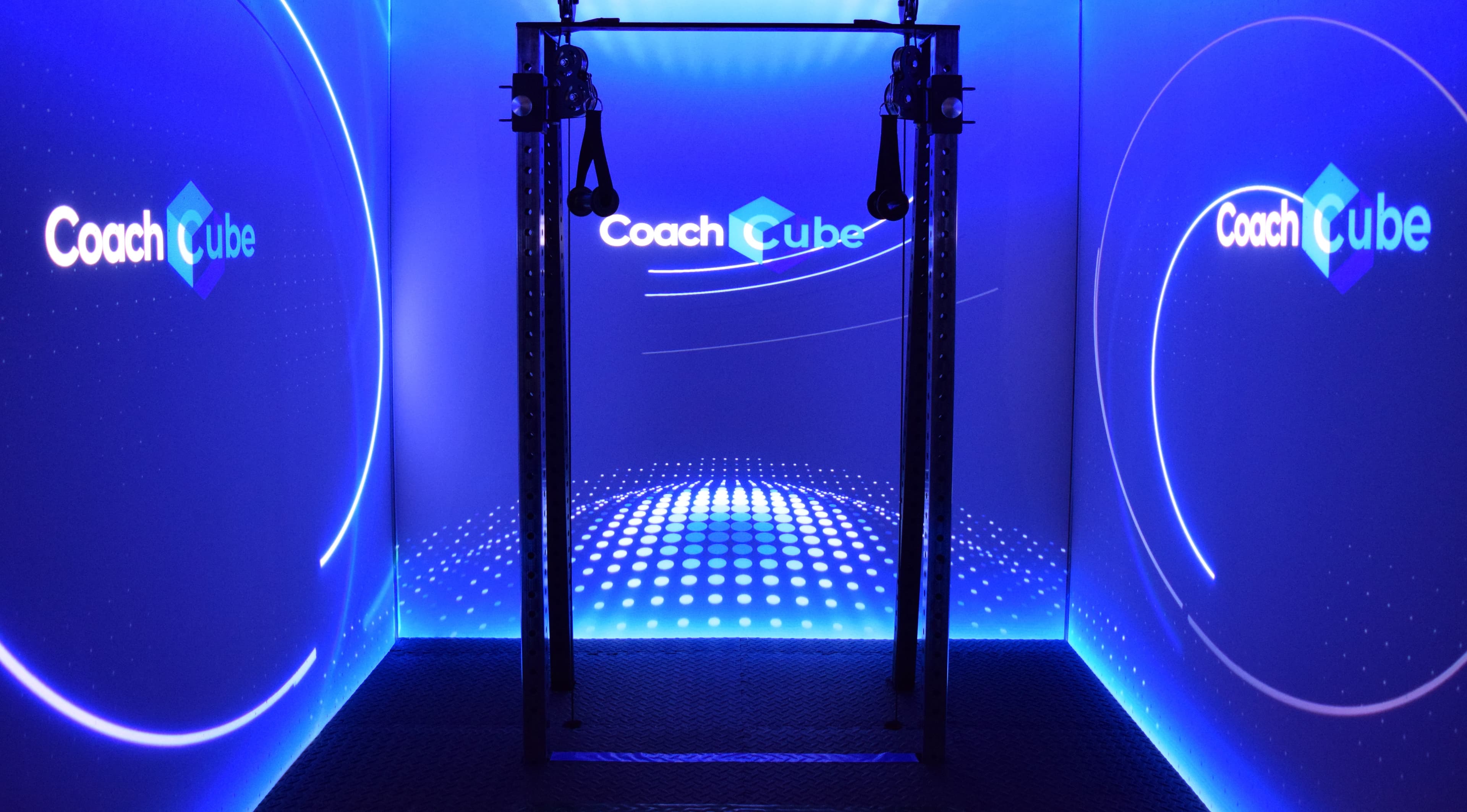 Inside the CoachCube — three projection screens and blue ambient lighting